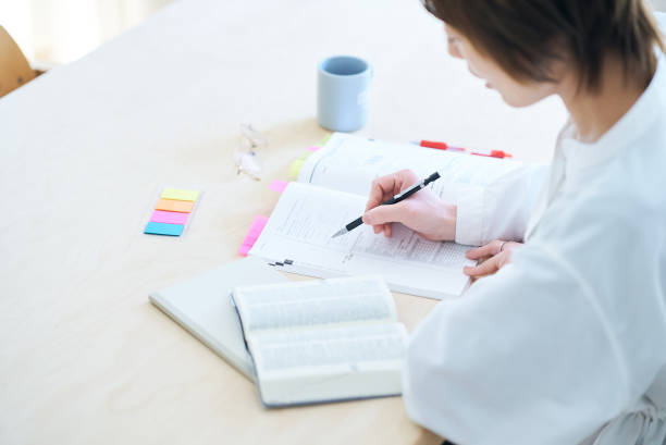 A woman in her thirties studying by text in the room