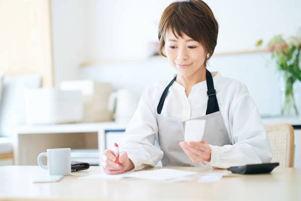 istock A woman in an apron checking receipts 1477913149