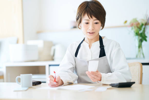 istock A woman in an apron checking receipts 1477913231