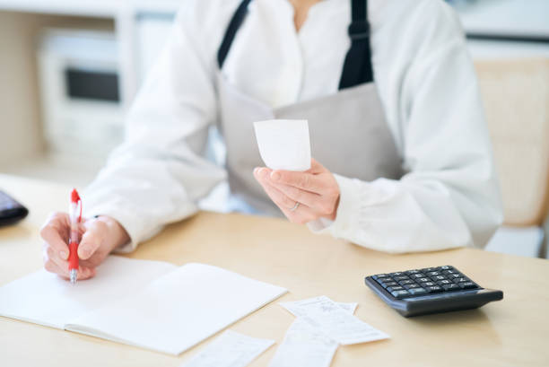 istock A woman in an apron checking receipts 1477914143