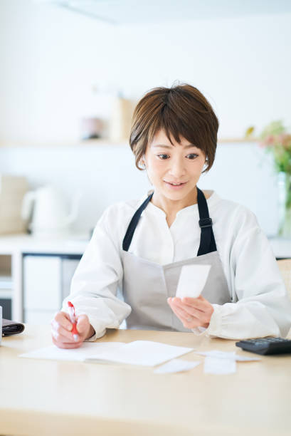 istock A woman in an apron checking receipts 1477914152