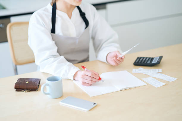 istock A woman in an apron checking receipts 1477914175