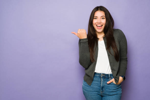 istock Happy attractive woman promoting a copy space ad 1477917090