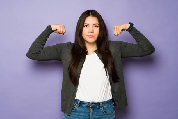 istock Strong beautiful woman doing bicep curls 1477917100