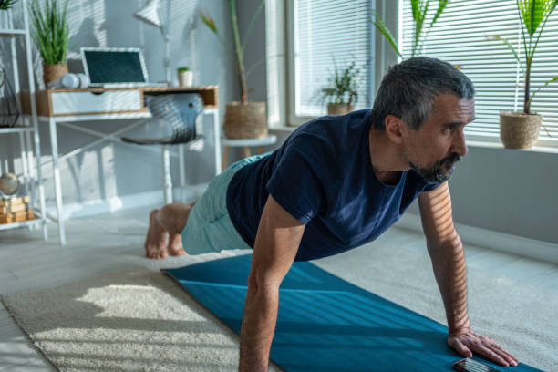 istock Mature athlete doing at-home isometric exercises to stay fit. 1477918447
