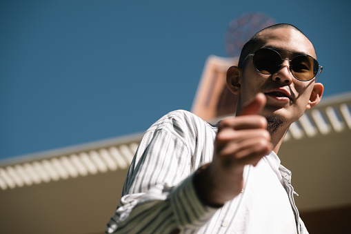 A young handsome stylish gentleman wandering around the campus, portrait, environmental portrait, relax, lifestyle portrait