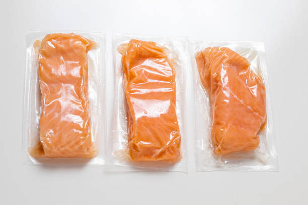 Airtight packed salmon on a white surface
