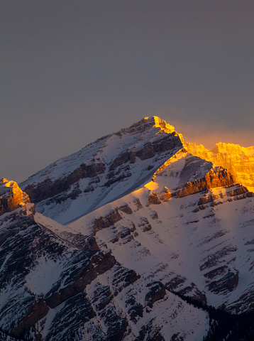 A view of the early morning light on a mountain in the Rocky Mountains of Canada.
