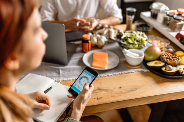 istock Woman using mobile health app for tracking food income parameters 1477930282