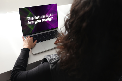 Woman using laptop with artificial intelligence screen