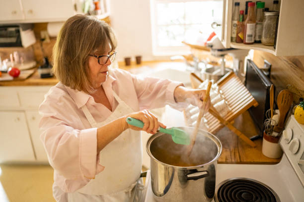 istock Woman Wearing an Apron While Cooking in the Kitchen 1477935300
