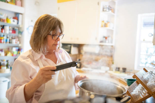 istock Woman Checking Temperature with Cooking Thermometer 1477935317