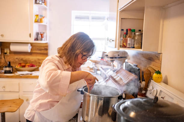 istock Cooking Woman Stirs a Boiling Pot in the Kitchen 1477935416