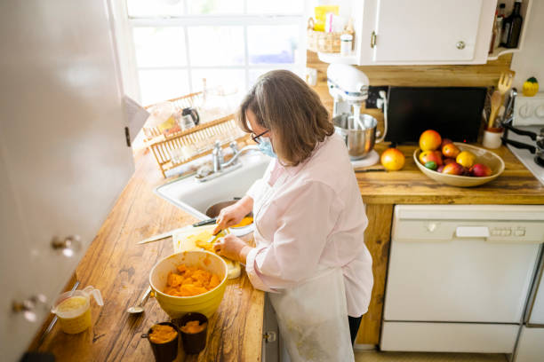 istock Woman Cutting Mangos in Florida Kitchen 1477935449