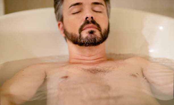 istock Man relaxing with his eyes closed in a hot tub 1477940134