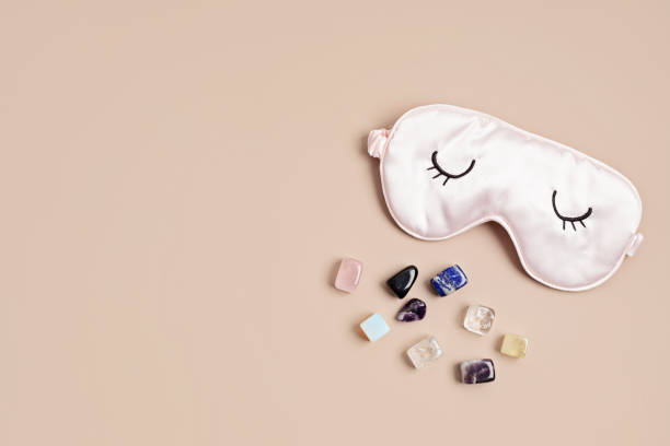 istock Healing chakra crystals and sleeping mask. Improving sleep quality with gemstones. Alternative therapy for physical, mental, emotional and spiritual well-being concept 1477940847