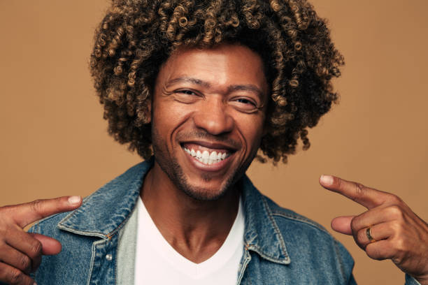 istock Black man pointing at own bright smile 1477941314
