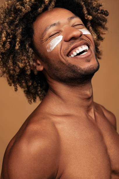 African American male laughing during spa session stock photo