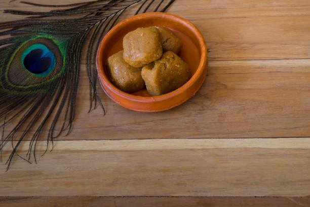 istock Mathura ka peda is served on a clay plate with peacock feather during celebration of Krishna janmashtami. This traditional Indian sweet originated in mathura is made of khoya or Mawa, ghee and sugar. 1477948391