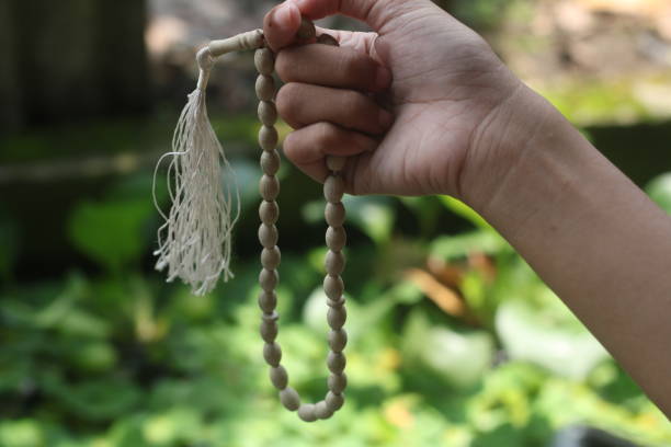 istock White prayer beads in women's hands 1477960226