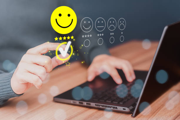 istock Man hand using computer laptop with popup five star icon for feedback review satisfaction service, testimonial. Customer service experience and business satisfaction survey. 1477963347