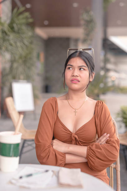istock A young woman hears a terrible backhanded complement and reacts with an irritated face. 1477964294