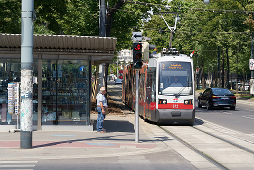 Vienna, Austria – June 20, 2022: Vienna, Austria – June 20, 2022: Traffic in the center of Vienna with a tram of line 2 at a traffic light