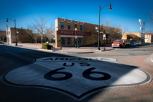 Winslow, Arizona, USA - March 9, 2023: Standing on a corner, in the downtown area, at old Route 66.