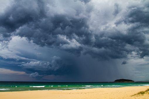 Dark dramatic storm cloud and rain over the coast, spring in Australia.