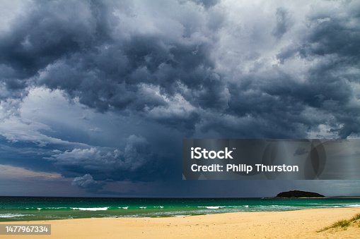 istock Dark dramatic storm cloud and rain over the coast 1477967334