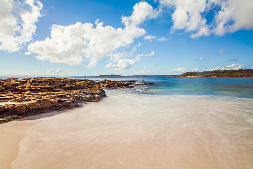 Blue ocean and white sand beach on a sunny day. South Coast, NSW, Australia