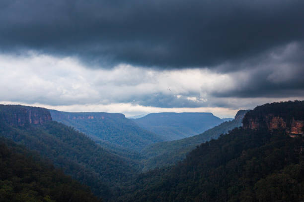 istock Dark stormy sky looming over mountain valley 1477967374