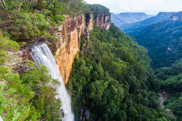istock Looking down over large waterfall flowing into the mountain valley 1477967380
