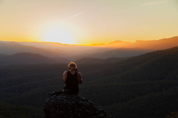 istock Young man photographing sun setting in the mountains rolling landscape 1477967623