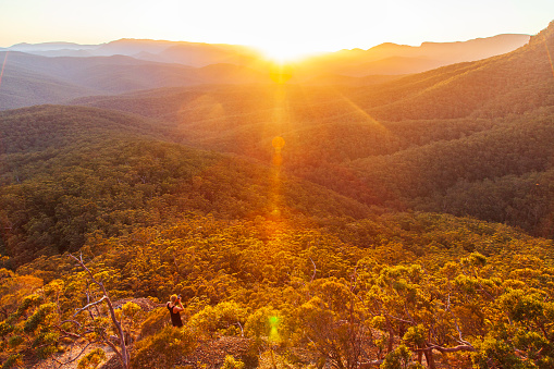 Sun setting in the mountains over forest and rolling landscape. South Coast, NSW, Australia.
