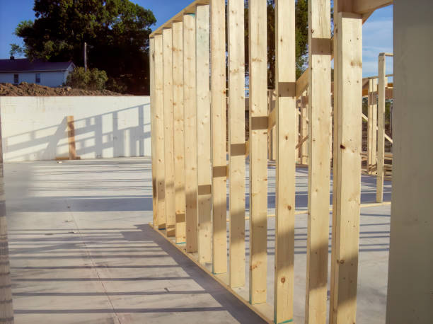 Wall frame being built on a slab-on-grade single story berm home. Wall frame being built on a slab-on-grade single story berm home. . High quality photo basement construction site construction blueprint stock pictures, royalty-free photos & images