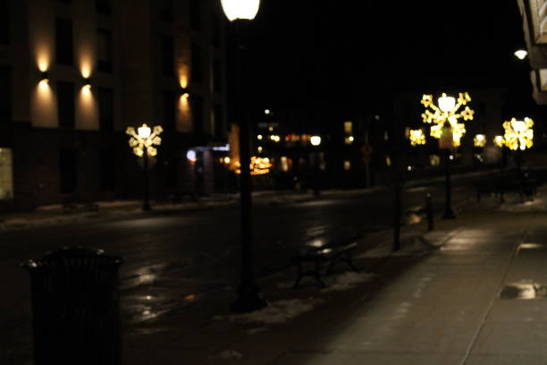 istock Downtown lit street surrounded by buildings 1477971080
