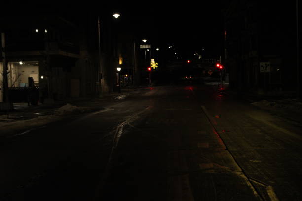 istock Downtown lit street surrounded by buildings 1477971090