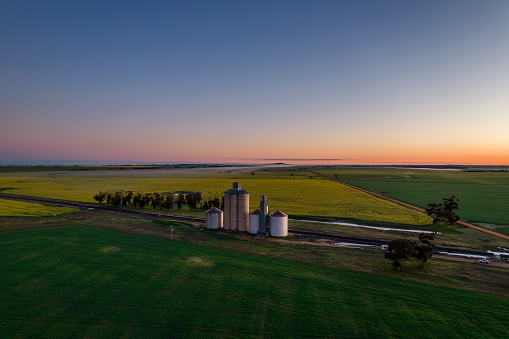 Early morning before sunrise looking down on silos and a rural scene.