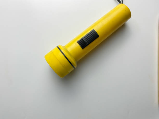 istock Yellow flashlight isolated on white background. For emergency and blackout 1477972616