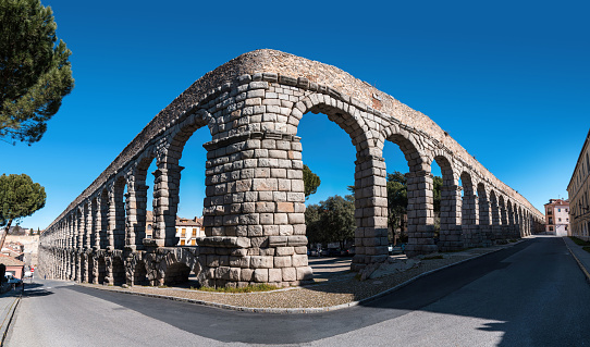 Panoramic view of curved corner of the ancient Roman aqueduct and old town Segovia Spain