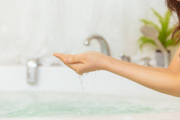 istock Hand touching water in bathtub. 1477979493