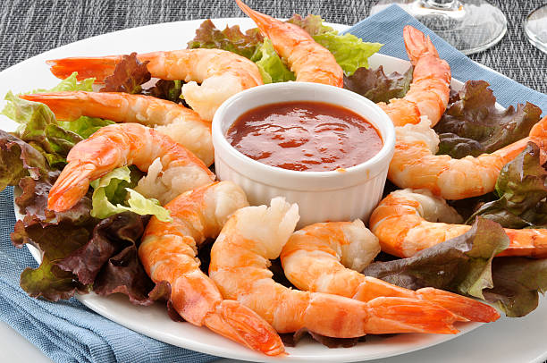 Shrimp cocktail closeup Closeup shot of tiger shrimp prawns on a bed of lettuce shrimp cocktail stock pictures, royalty-free photos & images