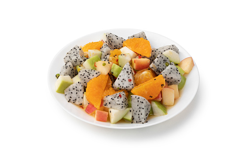 Fruit salad in plate on white background