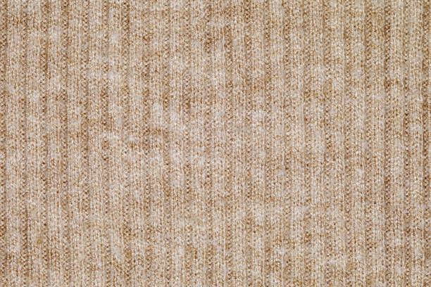 istock Beige fabric close-up knitted from spinning threads, background wallpaper, uniform texture pattern 1477991634