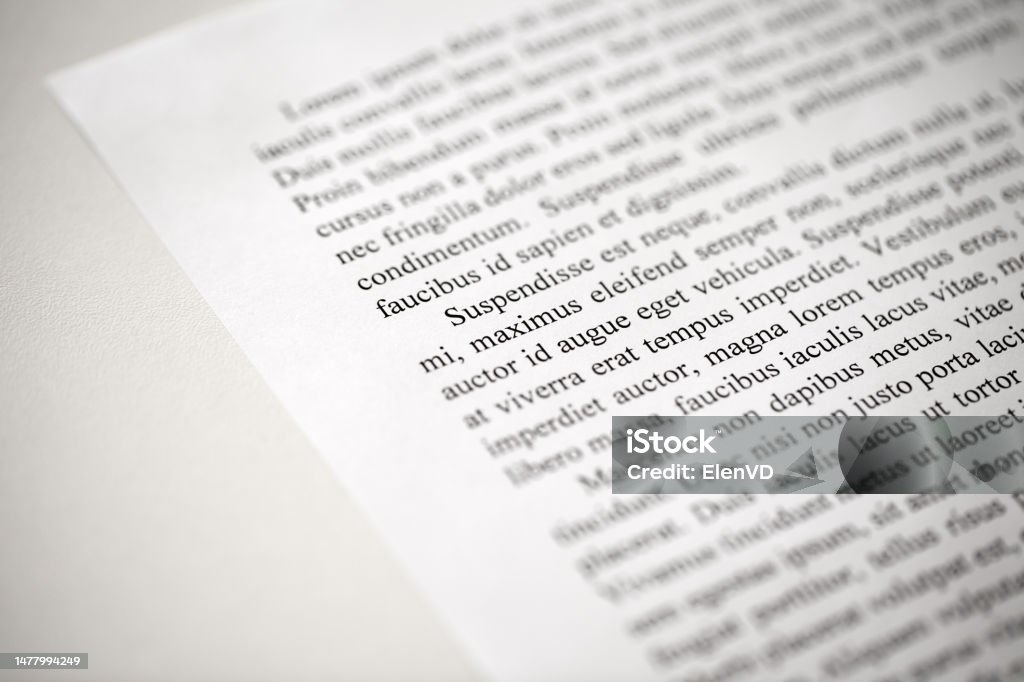 Lorem Ipsum dolor text on printed on paper in black and white, sample of document, side view, selective focus Angle Stock Photo
