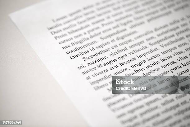 Lorem Ipsum Dolor Text On Printed On Paper In Black And White Sample Of Document Side View Selective Focus Stock Photo - Download Image Now