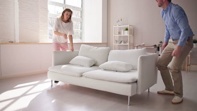 Couple Moving Couch Or Sofa Together