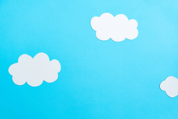 istock White paper clouds and sky concept on a blue paper, flat lay, top view 1477997455