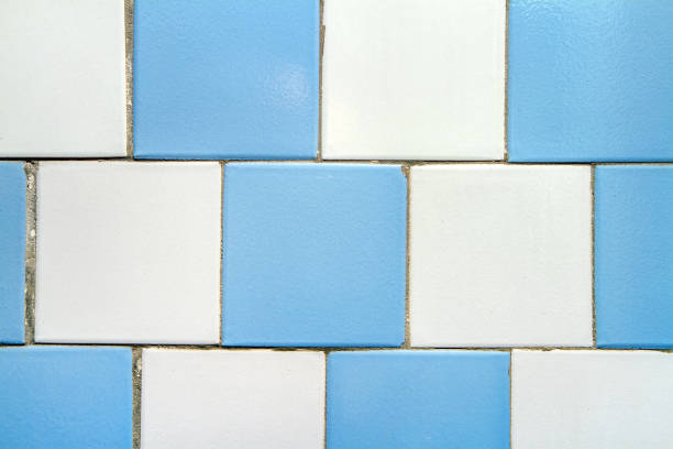 Old tiles. Texture of old tiles on the wall. Ceramic tiles on the old facade.
